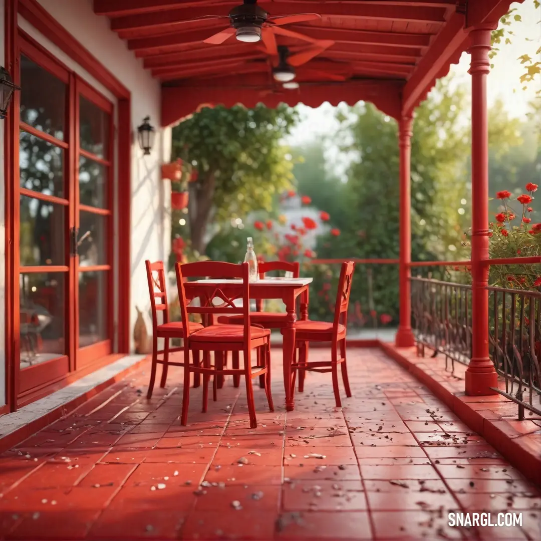 Red patio with a table and chairs and a red roof and red flowers on the ground. Color #800000.