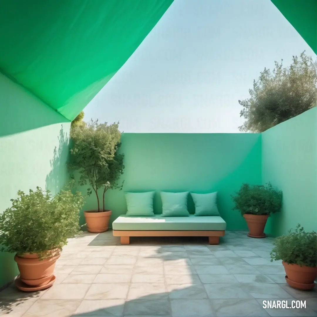 A cozy space featuring a white couch and green plants, with a green wall and awning above, creating a relaxing atmosphere. The medium aquamarine color provides a fresh, calming feel.