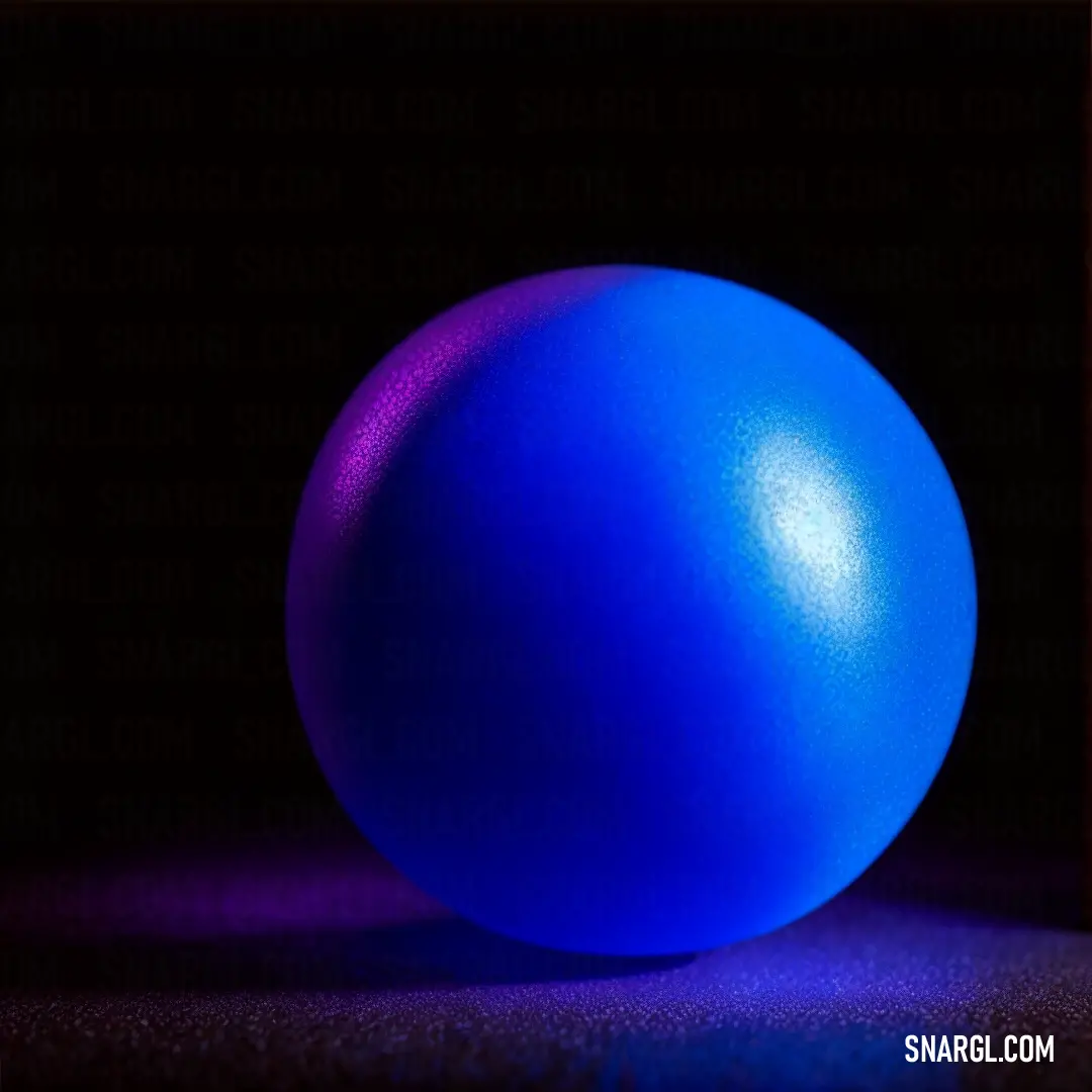 Blue ball on a black surface in the dark with a red frame around it