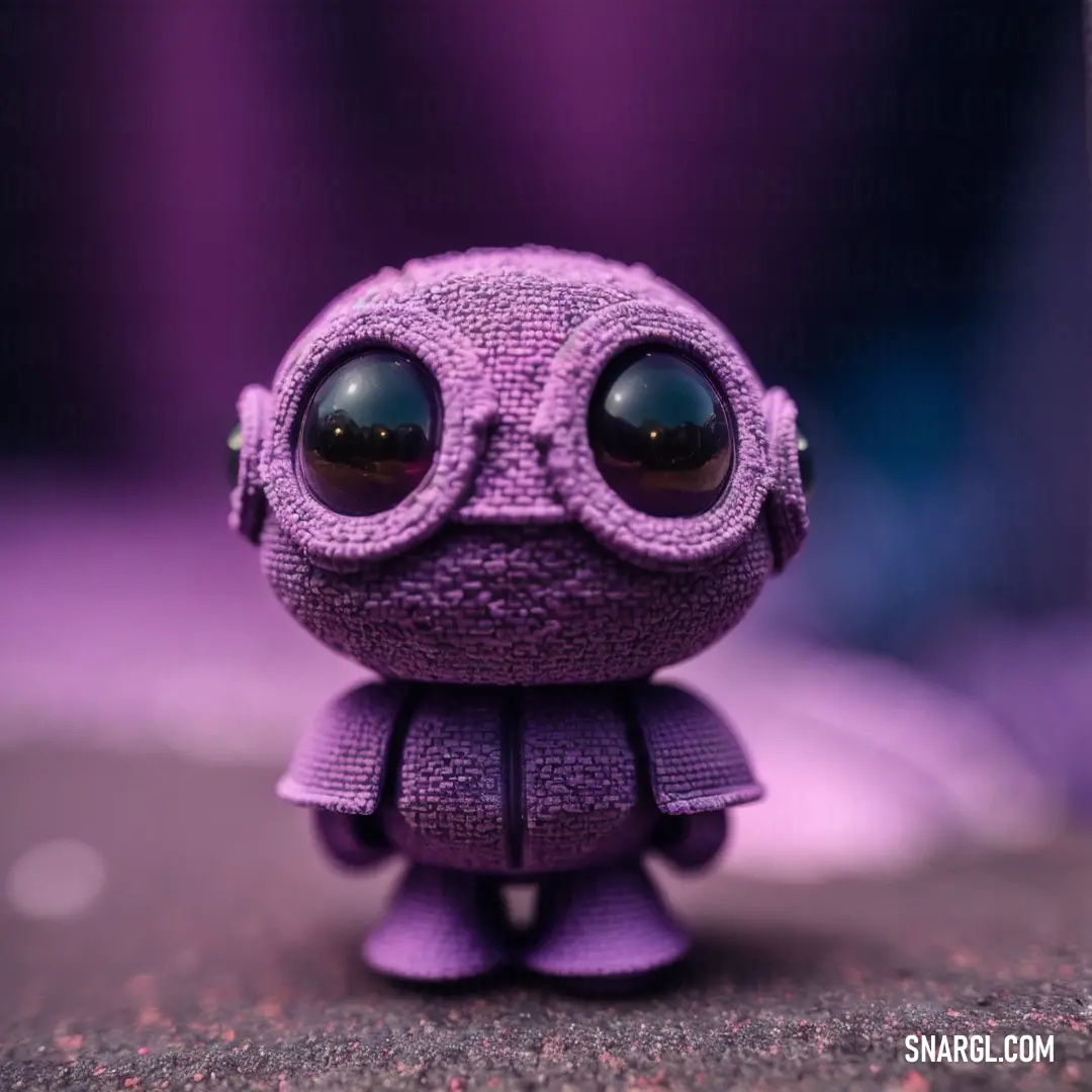 Purple toy with big eyes and a purple dress on it's body and a purple background