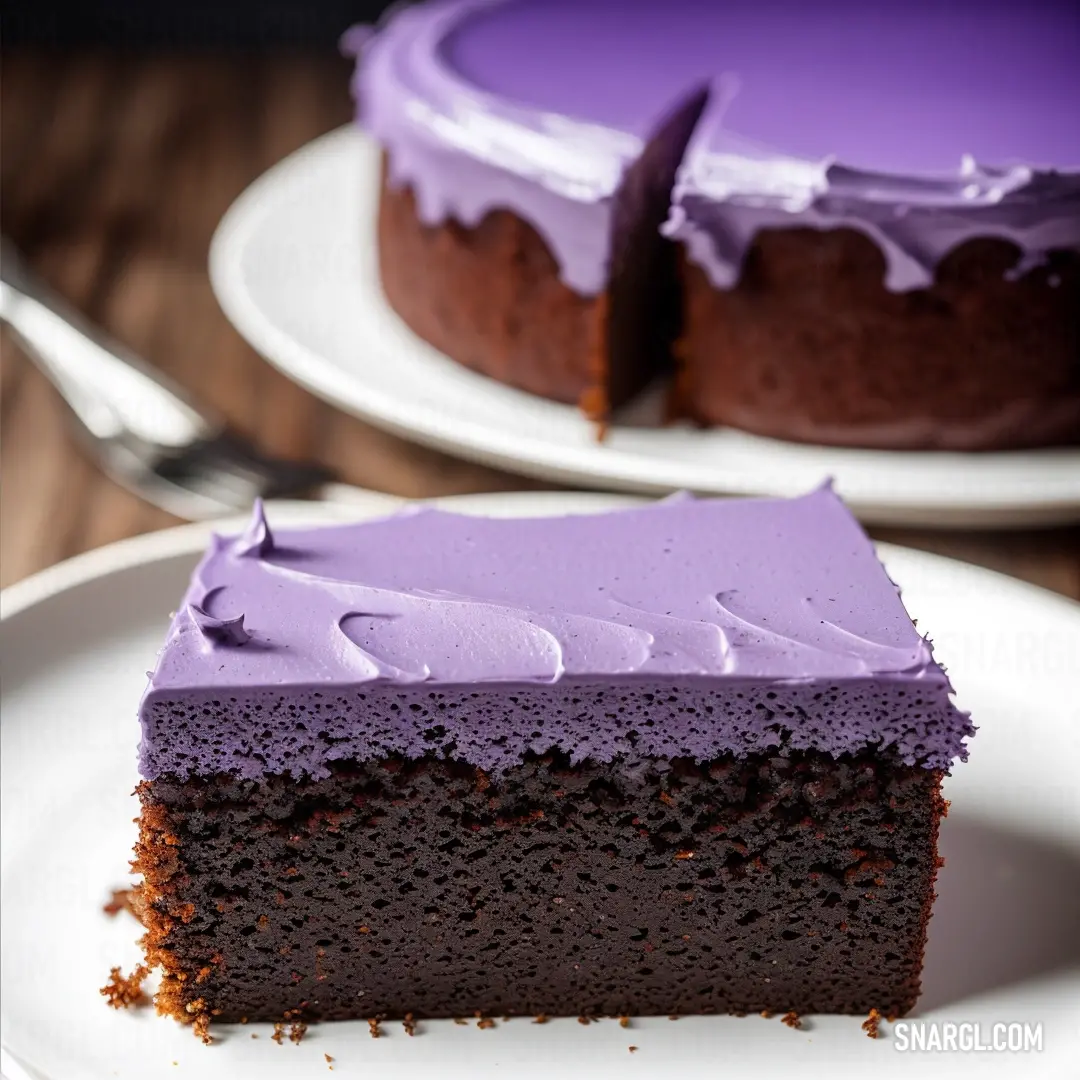 Slice of cake with purple frosting on a plate with a fork next to it