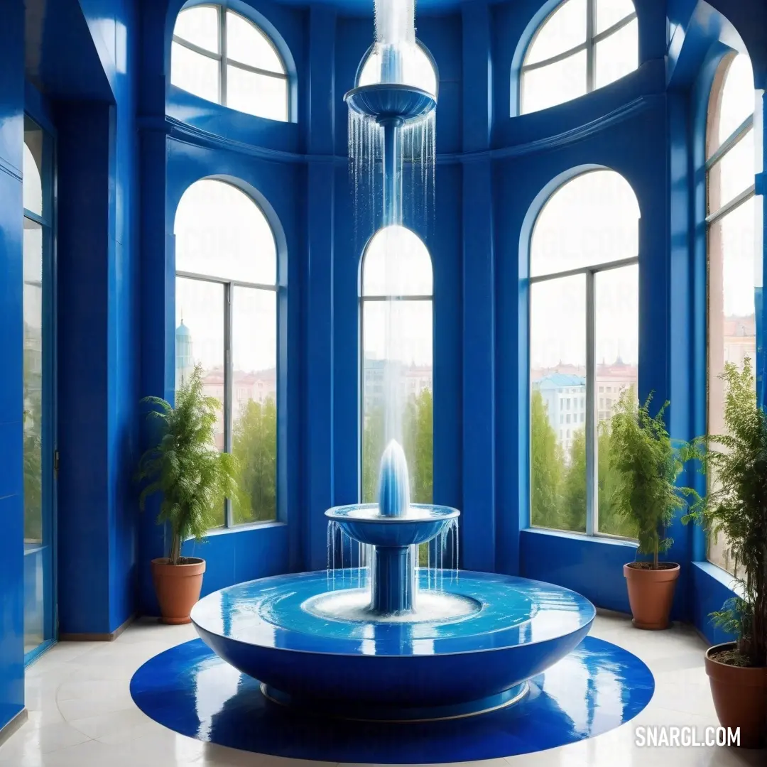 Fountain in a room with blue walls and windows and potted plants in the corner of the room. Example of Medium Persian blue color.