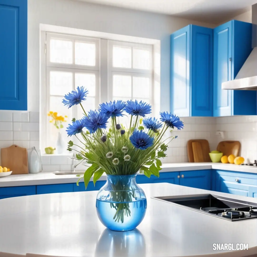 Vase of blue flowers on a kitchen counter top with blue cabinets and a stove top oven in the background. Color RGB 0,103,165.