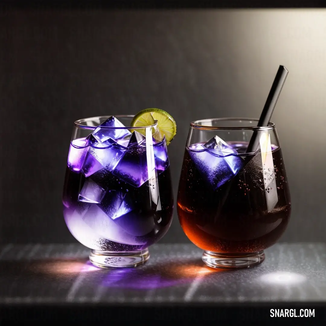 Two glasses of soda with ice and a lime slice on a table with a black background and a light shining on the glass