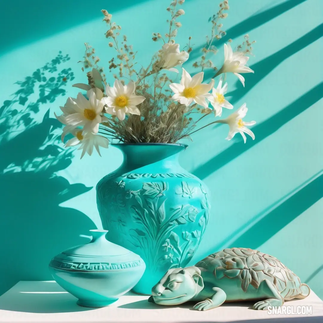 Medium turquoise color. Blue vase with flowers and a turtle on a shelf next to it on a blue wall with a shadow of a plant