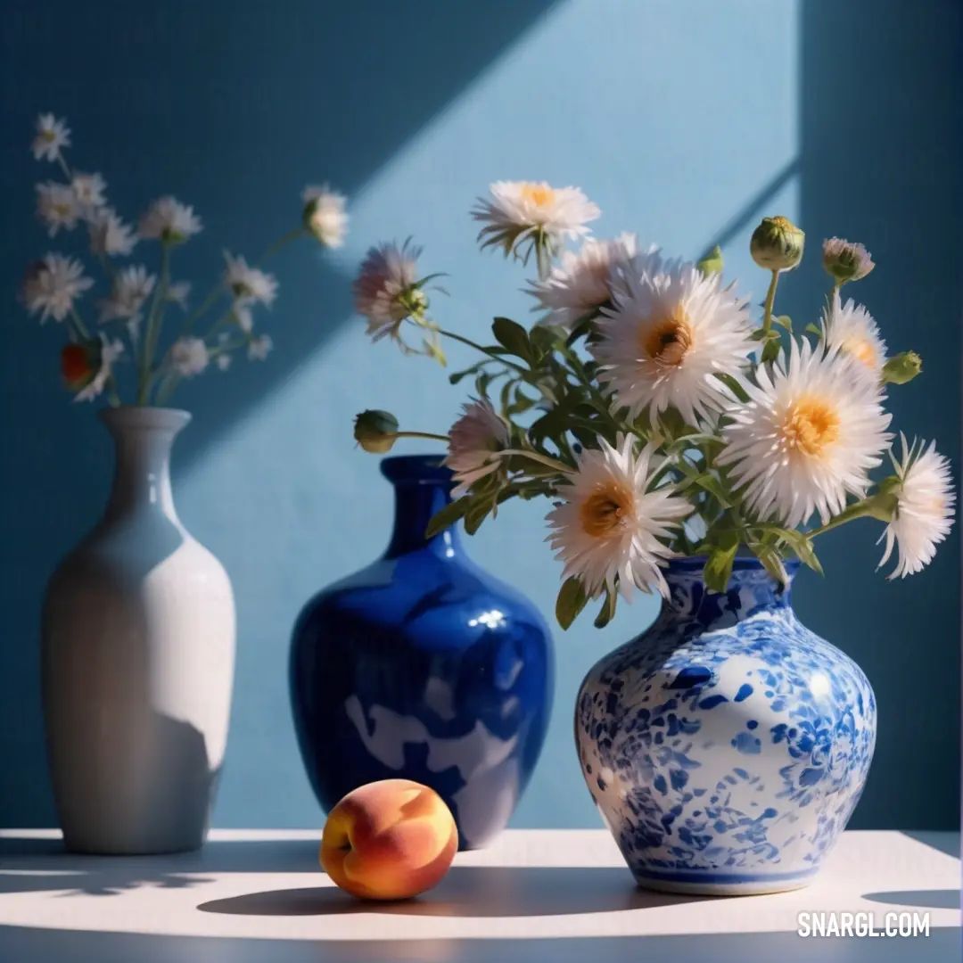 Vase with flowers and a peach on a table next to it, with a blue wall behind it. Color RGB 25,25,112.