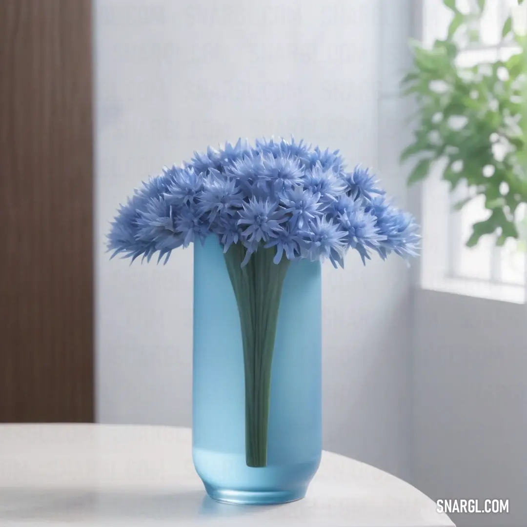 Blue vase with some blue flowers in it on a table next to a window sill with a potted plant. Color Moonstone blue.