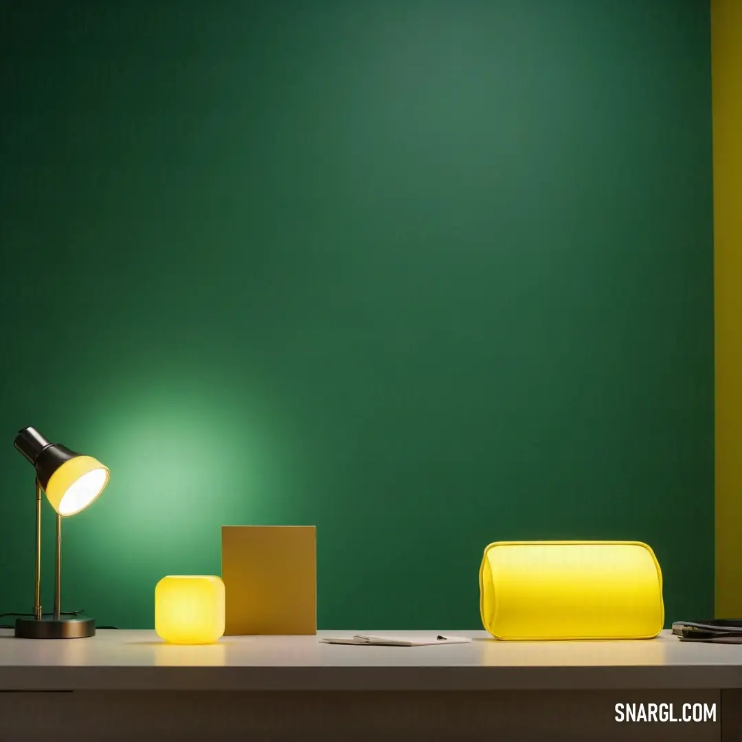 Desk with a lamp and a box on it next to a green wall and a yellow lamp on a table. Example of #18453B color.