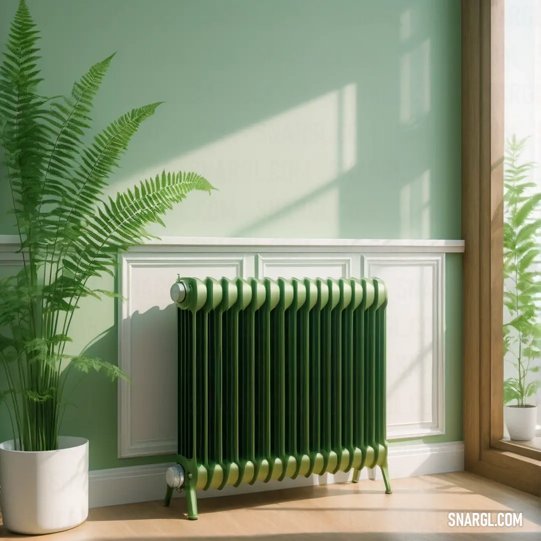Green radiator in a room with a plant in the corner of the room and a window. Color CMYK 50,0,55,74.