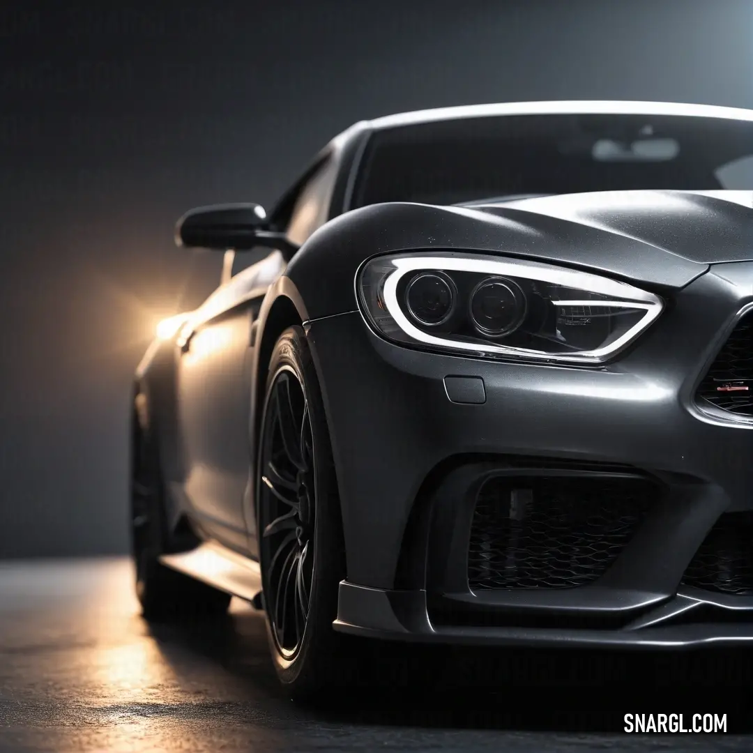 A close-up view of a sleek car positioned on a dark surface, illuminated by a focused beam of light that highlights its gleaming headlight. The contrasts create a striking visual that emphasizes its elegant curves and design.