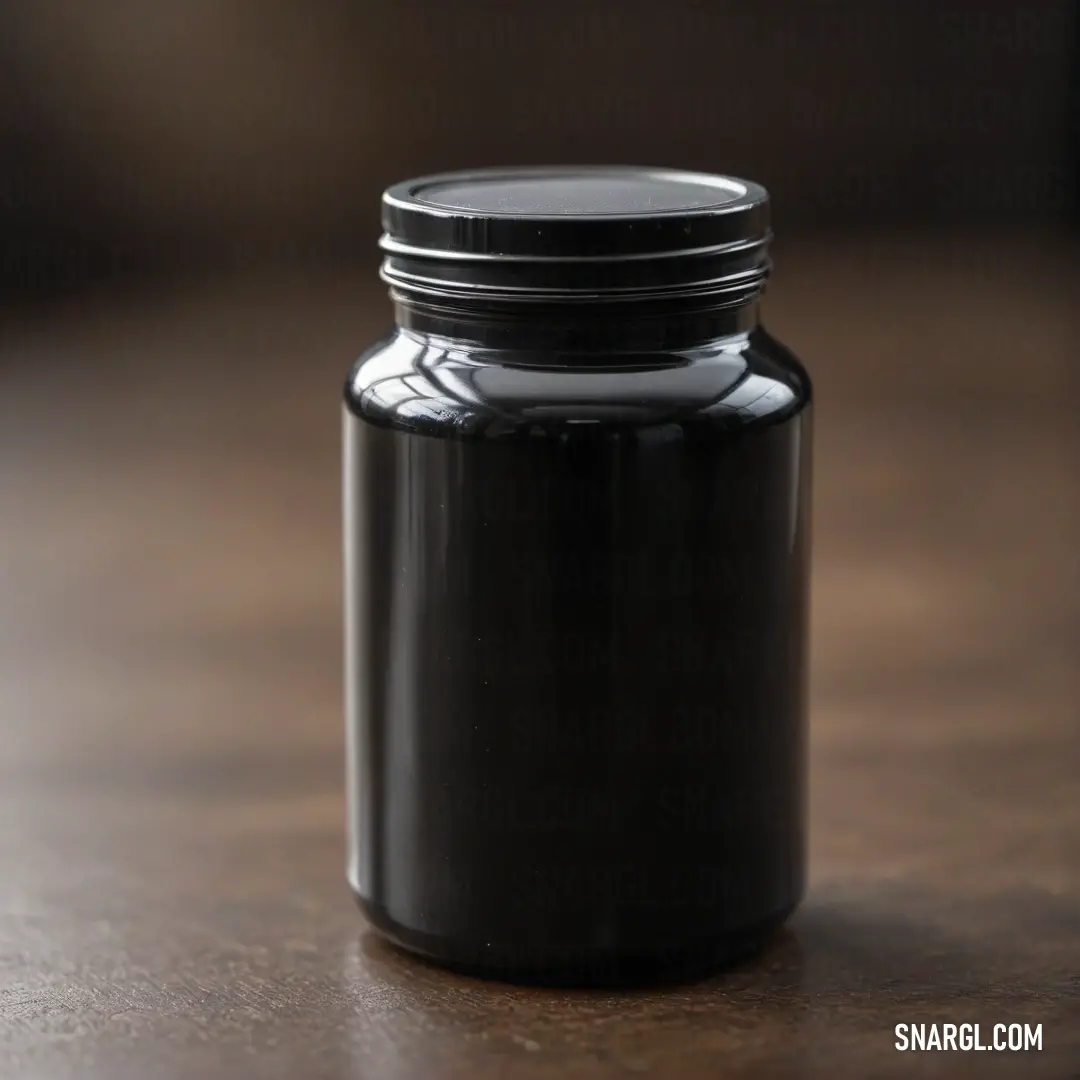 A matte black jar is artfully positioned atop a rustic wooden table alongside a chic black object, creating an intriguing contrast between organic and modern elements.