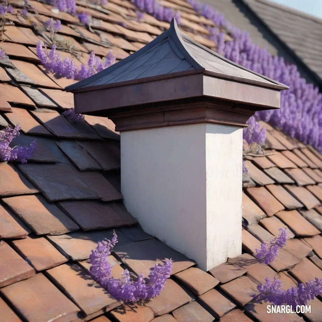 A picturesque roof features a sturdy chimney, accented by blooming purple flowers, creating a lovely scene that blossoms with color and charm, inviting beauty into the everyday.