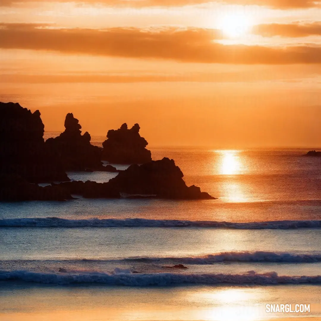 Sunset over the ocean with a person walking on the beach in the distance. Color NCS S 0540-Y30R.