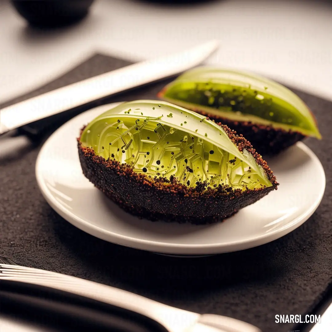 A plate holds a slice of bread filled with a green fruit, surrounded by a knife and fork. The setting feels both inviting and elegant, with soft lighting and a hint of freshness from the fruit.