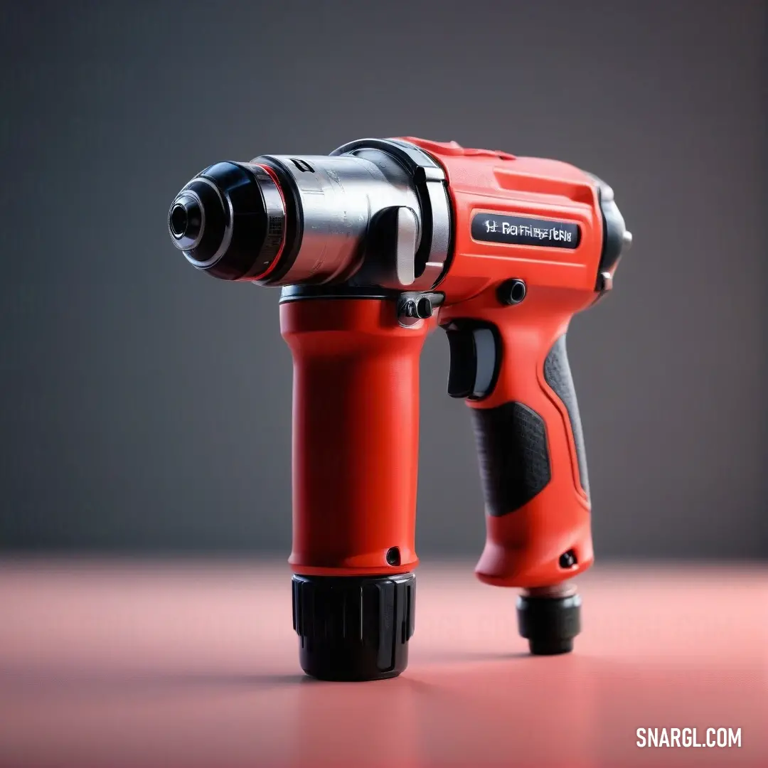 A bold red and black drill is positioned on a table against a muted gray background. This sturdy tool exudes strength and reliability, perfectly highlighted by the warm tones of NCS S 0550-Y60R.