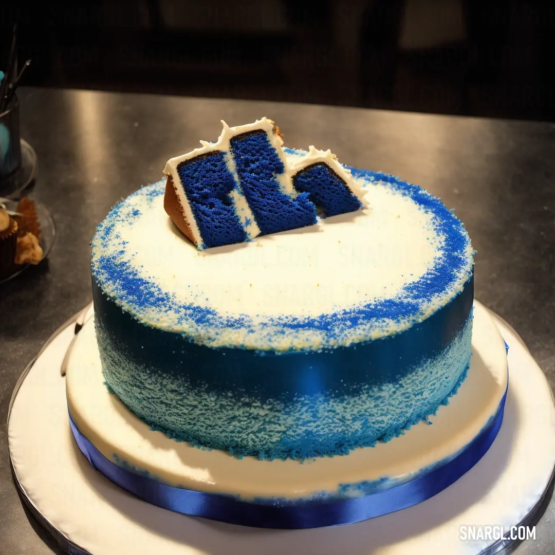 Cake with blue frosting and a blue number on top of it on a table with a blue ribbon. Color #F7F6F9.