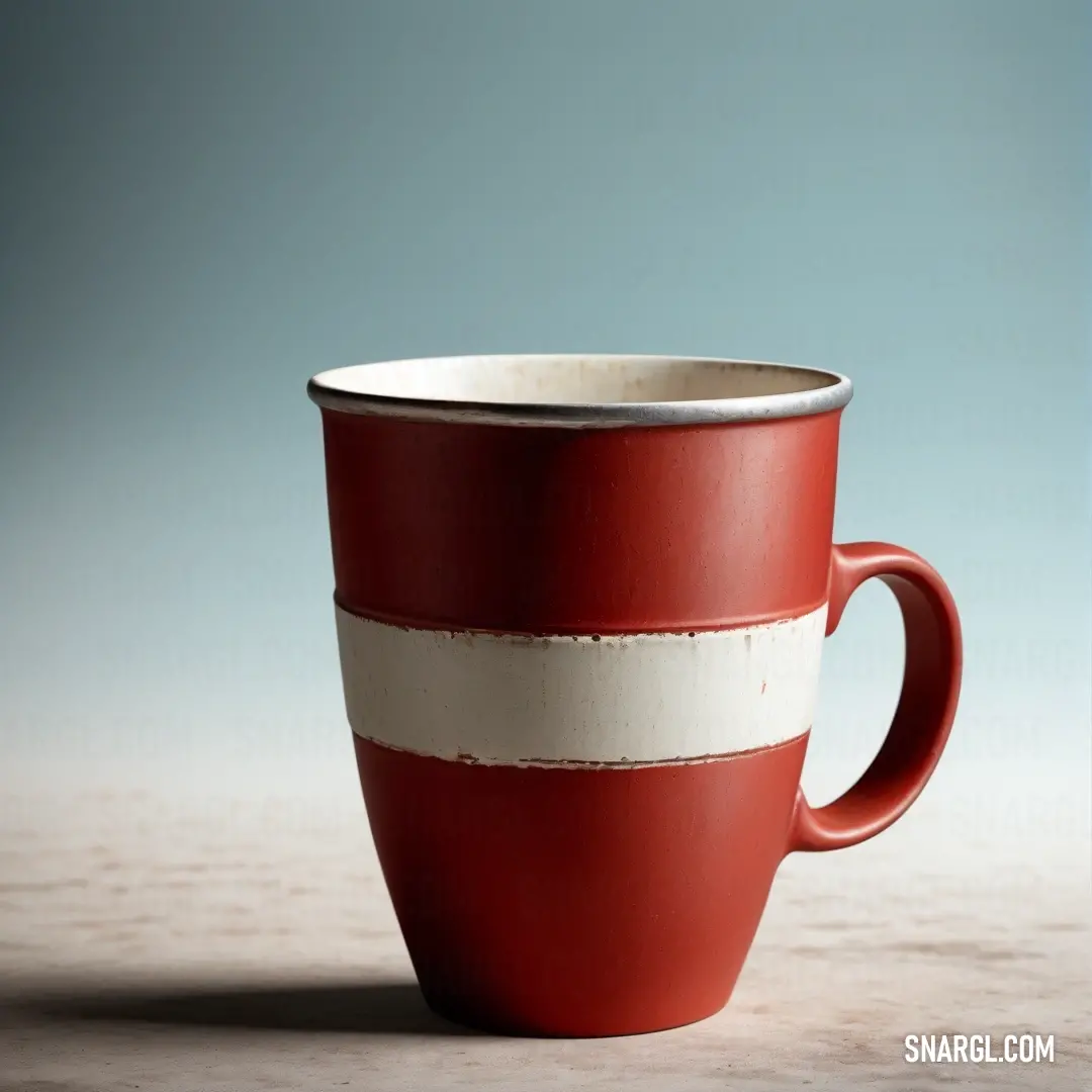 Red and white coffee cup on a table top with a blue background. Example of CMYK 0,2,12,0 color.