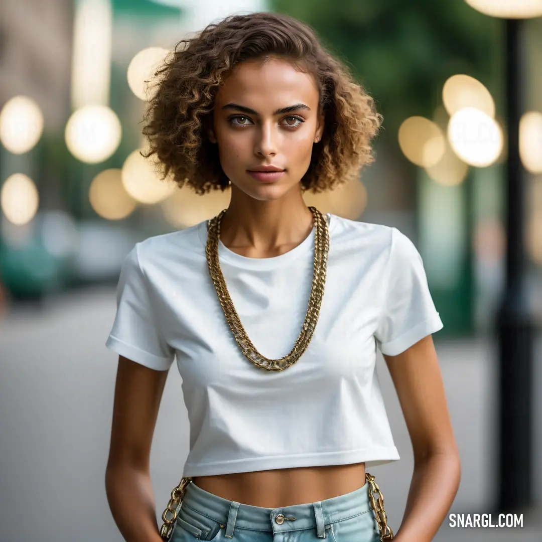 Woman with a white shirt and a gold chain necklace on her neck. Example of #F0FCF5 color.