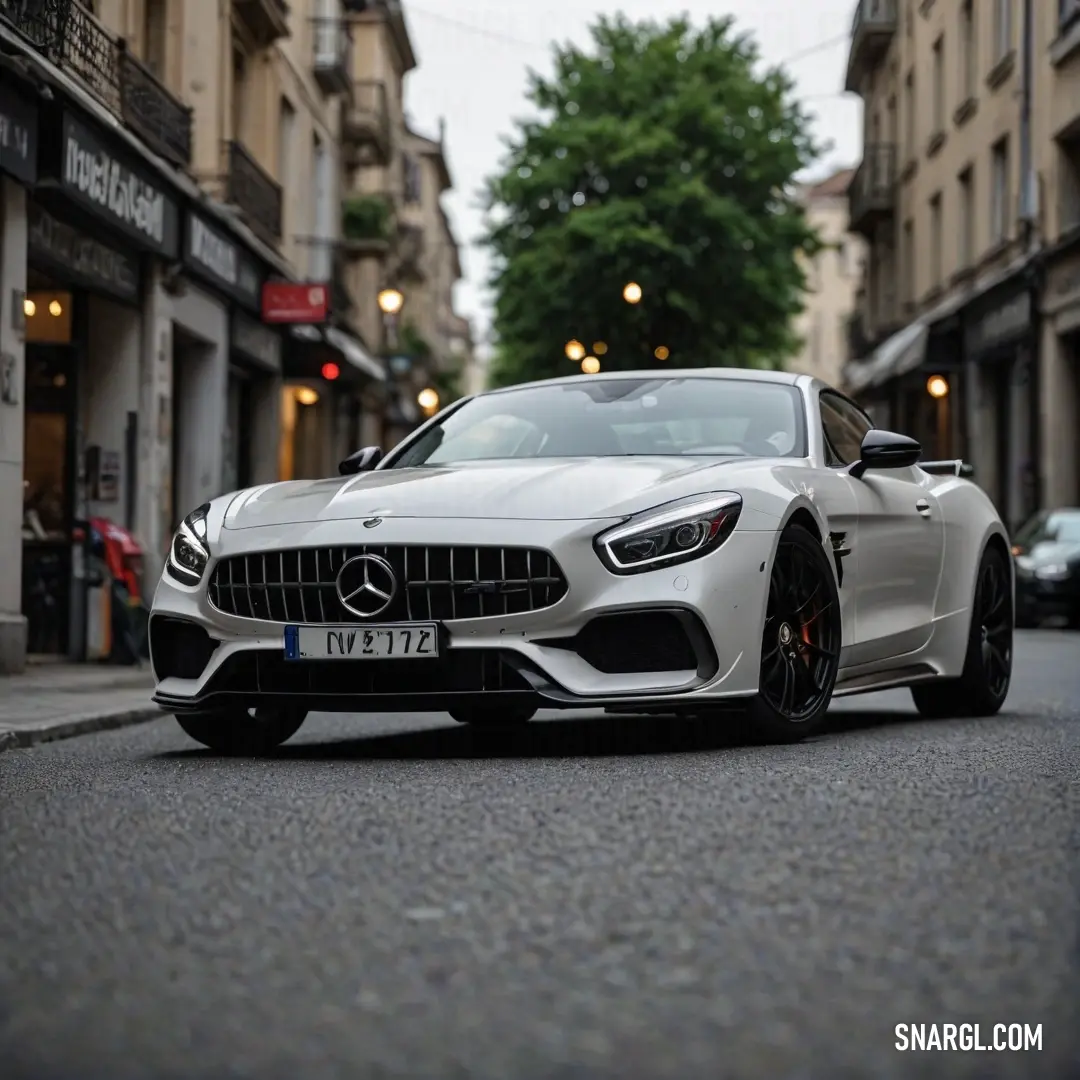 A sleek white Mercedes sports car parked gracefully on a bustling city street, positioned in front of an impressive building that signifies modern urban living and style.