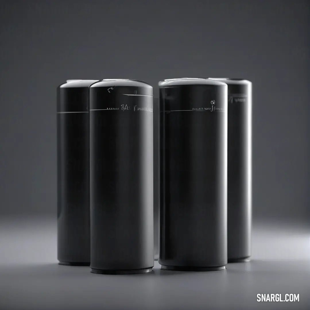 Three black cylindrical containers are artfully arranged in a dimly lit room, rays of light illuminating their sleek surfaces, creating a mysterious yet captivating atmosphere.