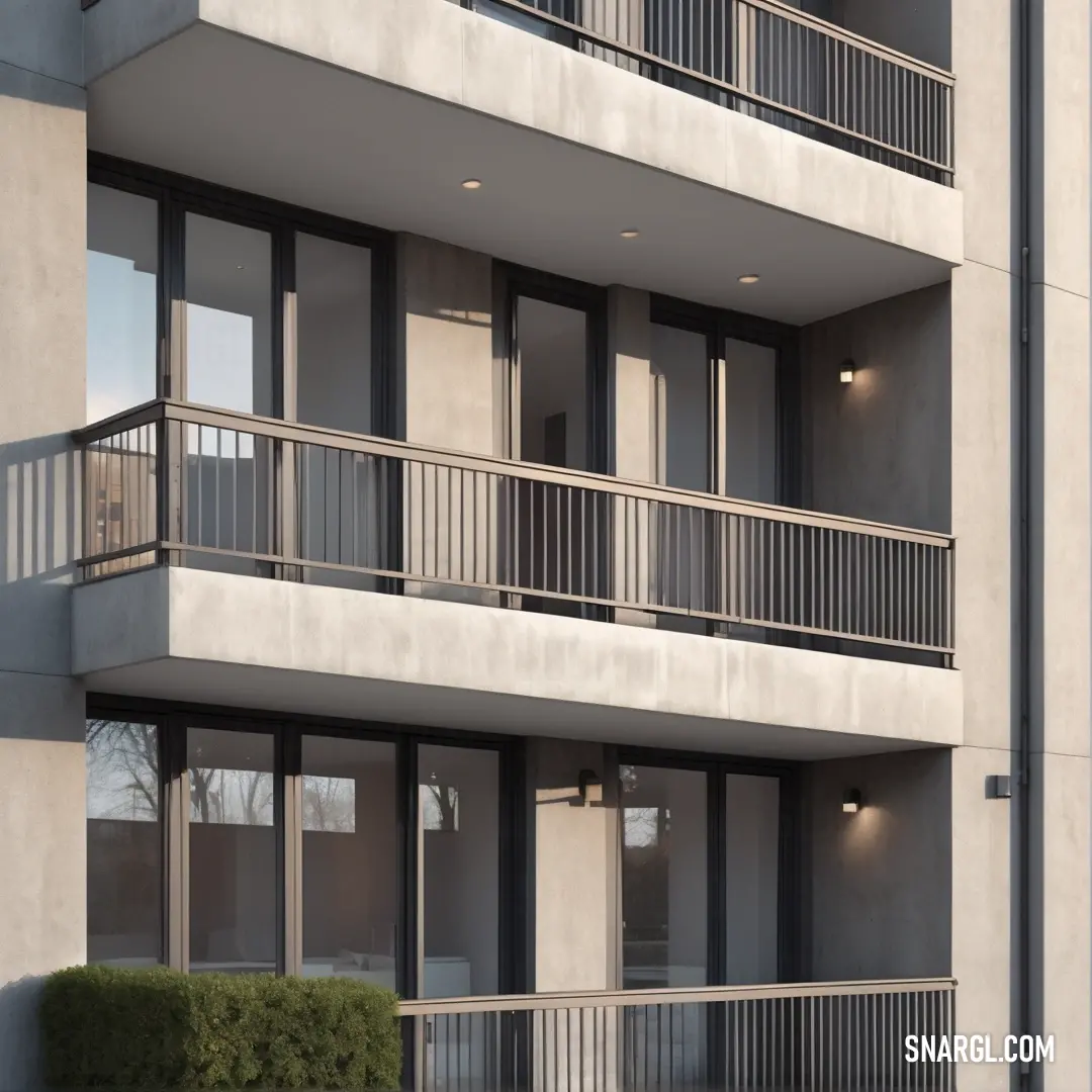 An impressive building showcasing multiple balconies, complete with a clock adorning its side. Enhanced by the sophisticated NCS S 1005-Y10R color, this structure reflects modern architecture and functional beauty seamlessly.