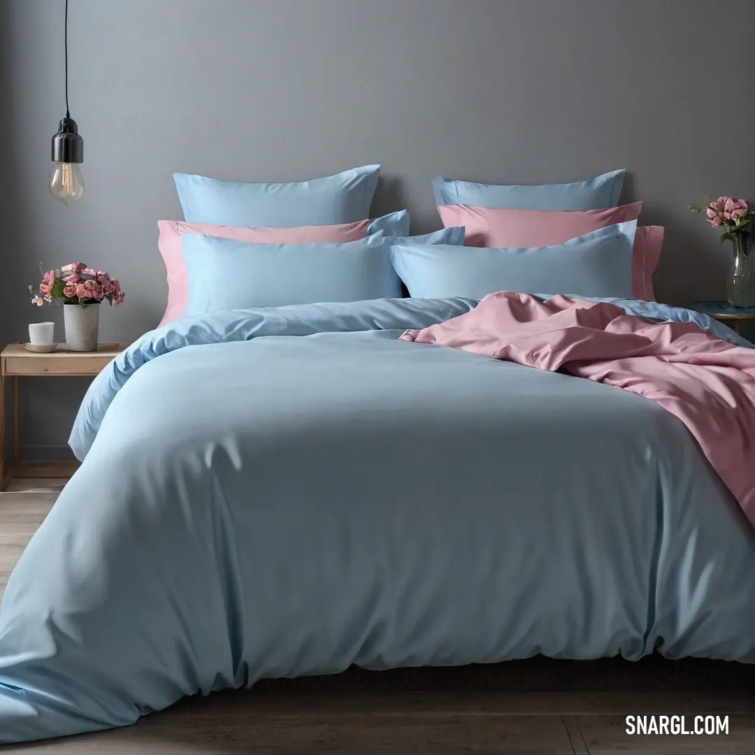 An inviting bed adorned with a cozy blue comforter and soft pink sheets exudes warmth, creating a delightful retreat, complete with plush pillows for ultimate relaxation and comfort.