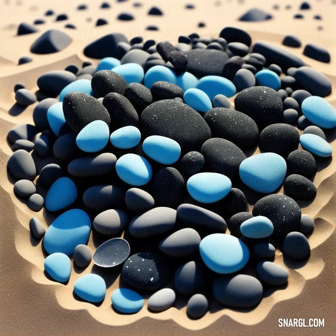 NCS S 1030-R80B color example: Pile of black and blue rocks on a table top with sand and water in the background