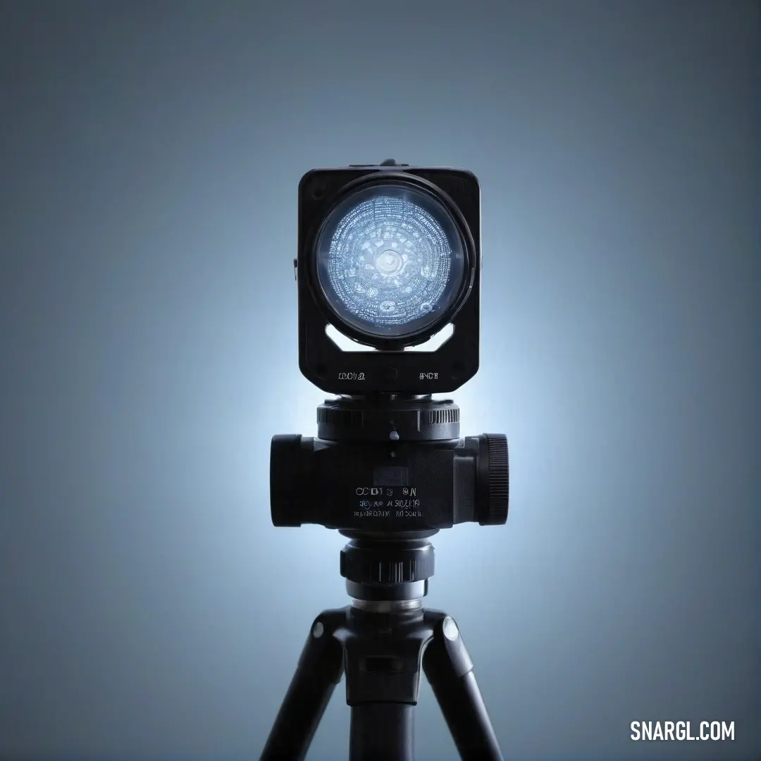 A stylish light mounted atop a steady tripod sits gracefully on a tabletop, next to a sleek camera, creating a dynamic presentation that speaks to the craft of photography and the artistry of illumination.