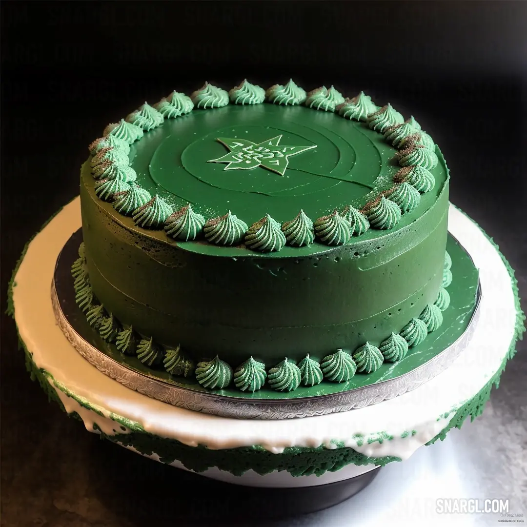 NCS S 1040-B90G color. Three layer green cake with white frosting on a plate on a table with a black background