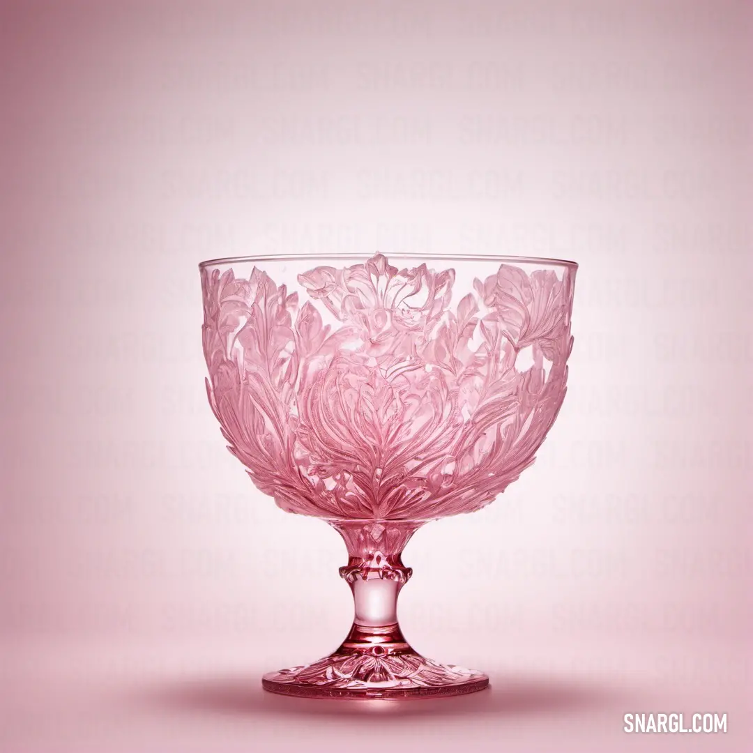 Pink glass bowl with a flower design on it's rim and a pink background. Example of CMYK 0,55,20,0 color.