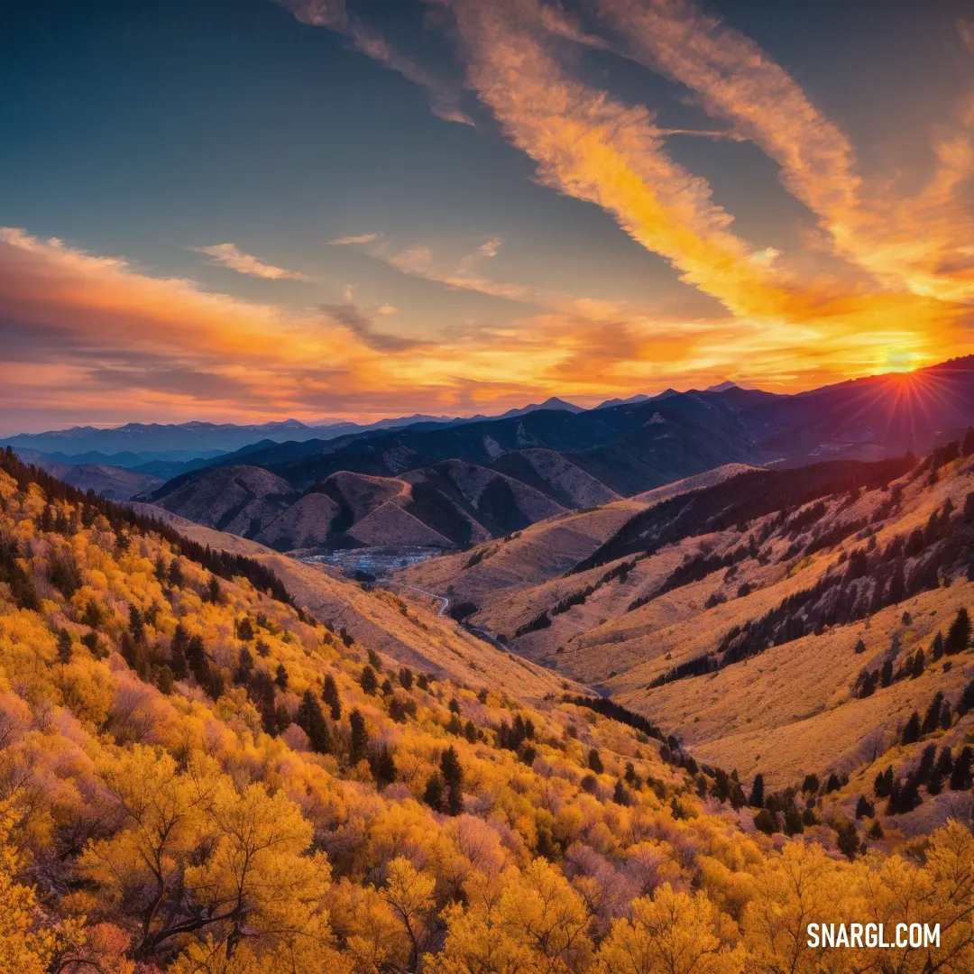 Beautiful sunset over a mountain range with yellow trees and grass in the foreground. Example of NCS S 1050-Y20R color.