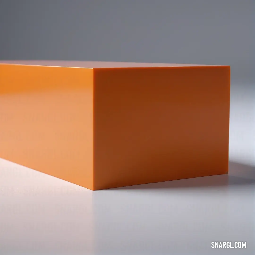 A square orange object casting a shadow on a white surface, illuminated by a soft light that enhances its textures and shapes, creating a visually striking composition.