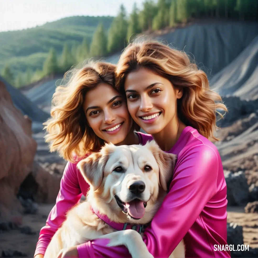 Two women are hugging a dog in a field of rocks and trees in the background. Example of CMYK 0,90,20,5 color.
