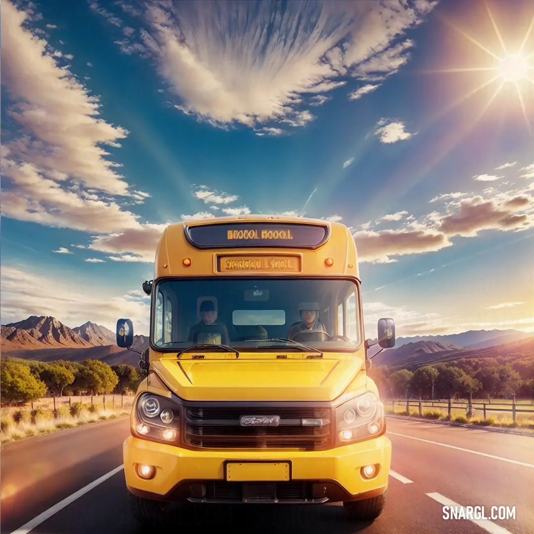 Yellow school bus driving down a road with mountains in the background. Color NCS S 1080-Y10R.