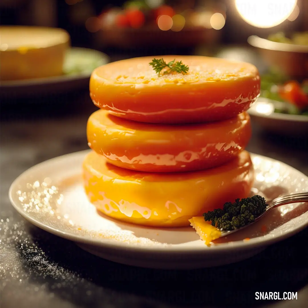 Stack of cheese covered donuts on a plate with a fork on the side of the plate. Color RGB 236,98,0.