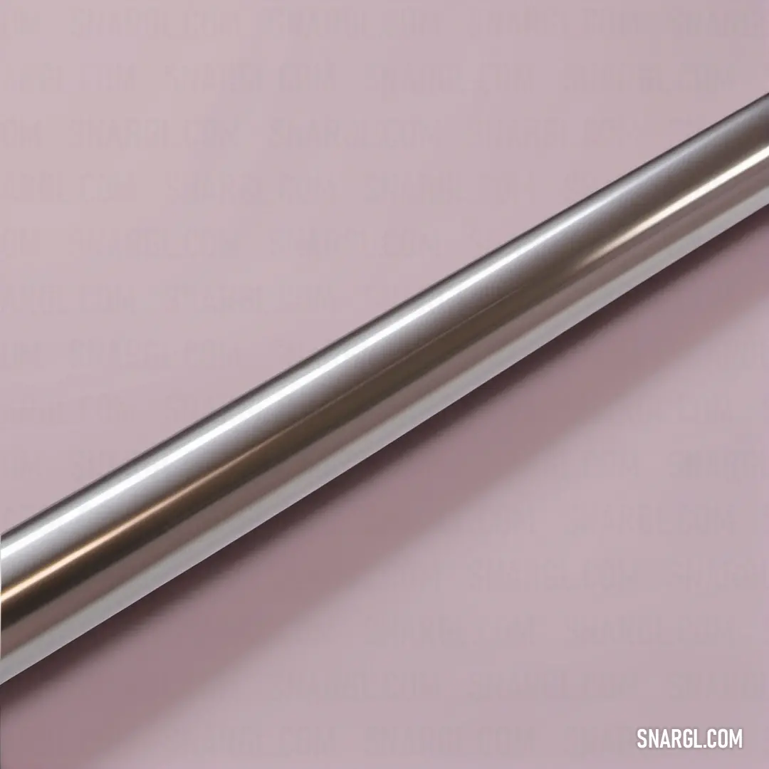 A sleek, shiny metal tube rests elegantly against a vivid pink backdrop, showcasing the contrast of materials and colors. This image captures the essence of industrial design against a vibrant hue, emphasizing the tube's polished surface and intricate det