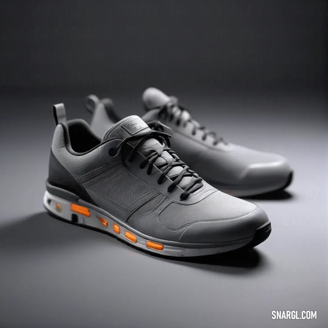 A visually appealing pair of grey shoes featuring vibrant orange lights, set against a depth of black, exuding modernity and style.