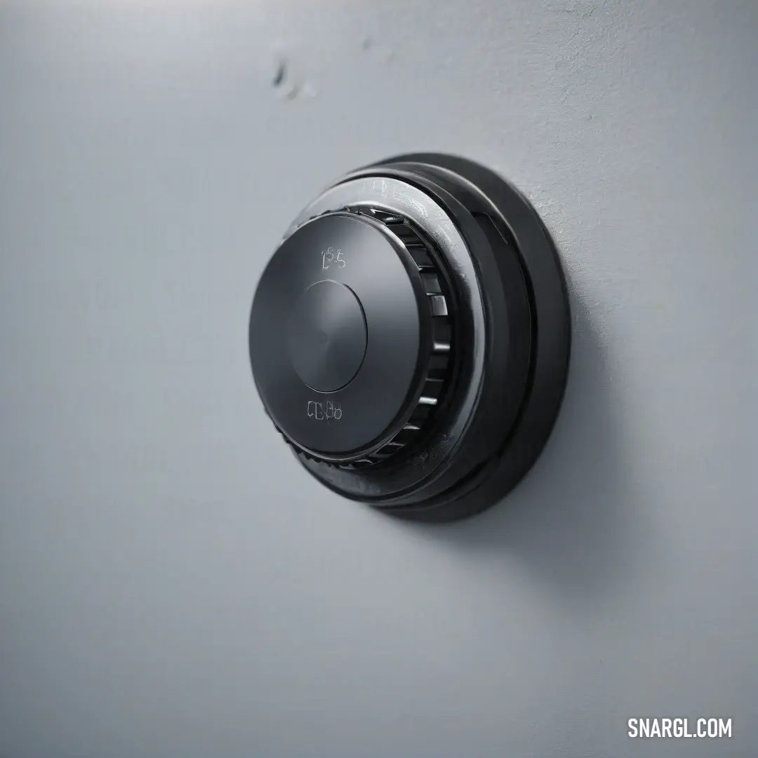 This eye-catching black knob is set against a pristine white wall, accompanied by a matching black handle. Their contrasting colors create a striking visual that draws attention to the elegant simplicity of everyday hardware in a well-designed space.