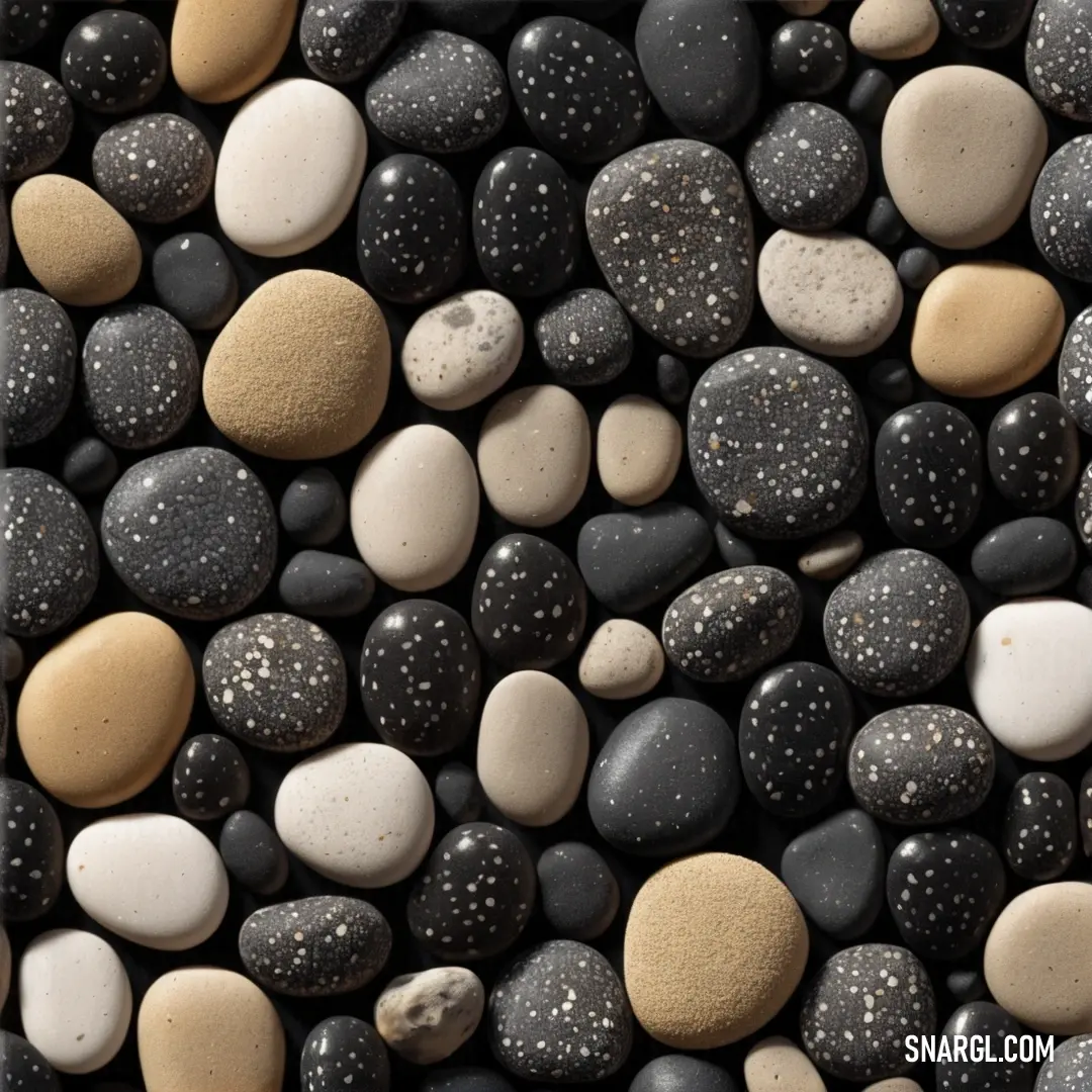 Bunch of rocks that are all together on a table with a black background. Color #D6B47A.