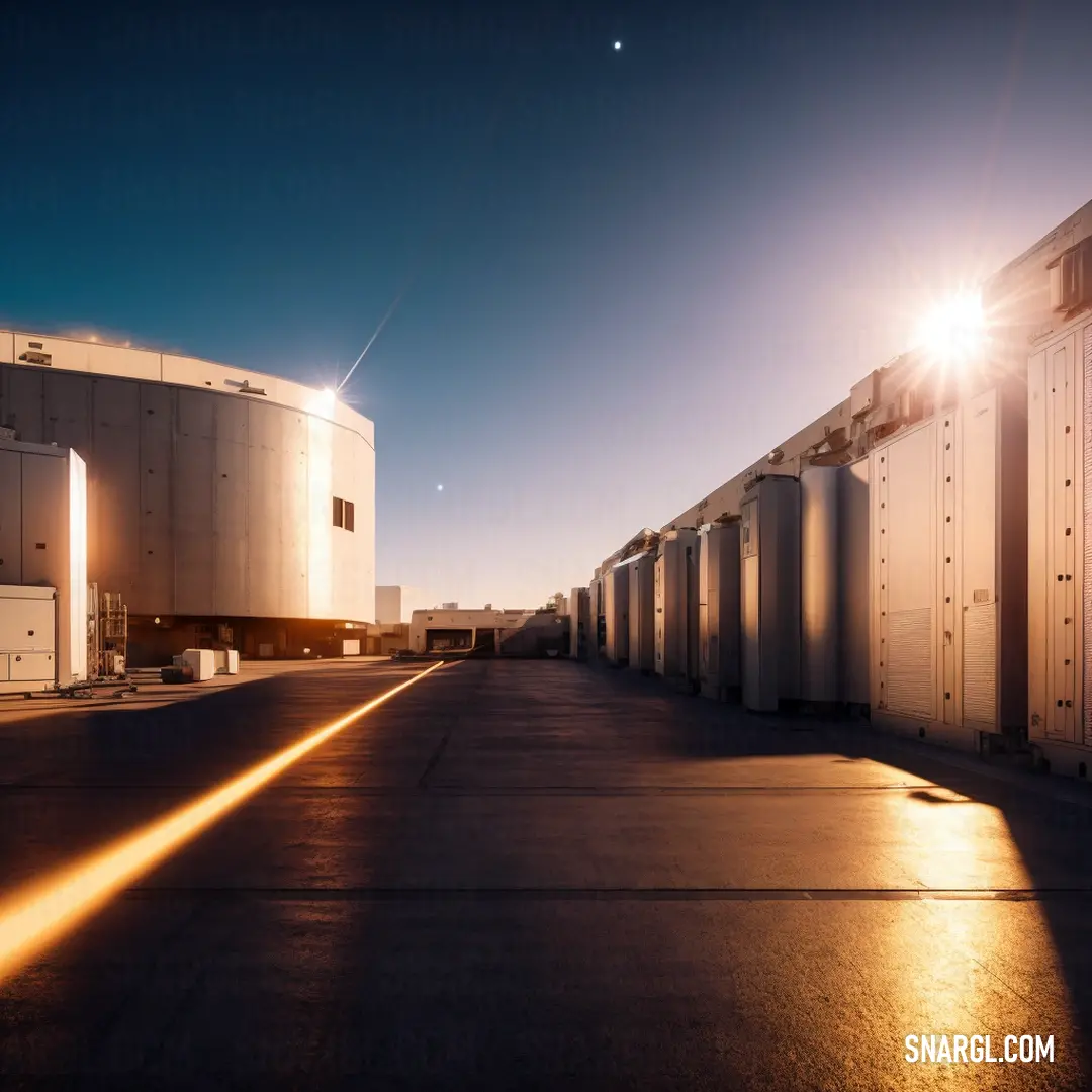 Row of white storage tanks next to each other on a street at night time with the sun shining. Color RGB 221,178,126.