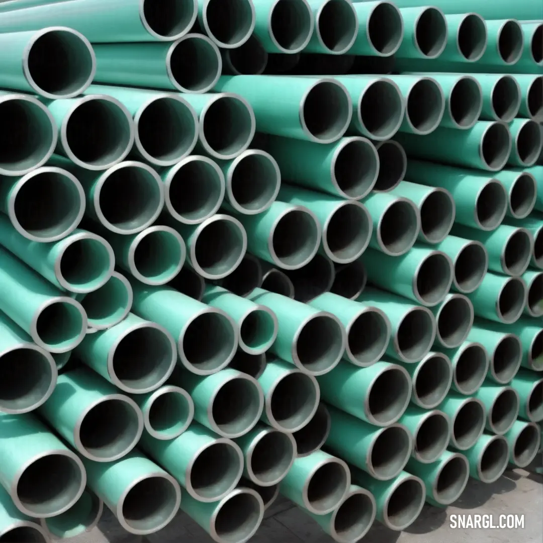 Stack of pipes stacked on top of each other in a warehouse area. Example of #73CEB4 color.