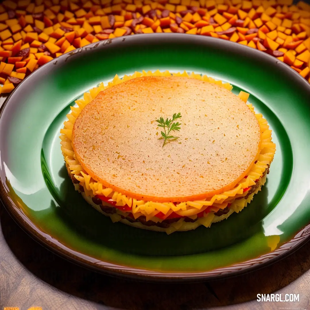 Plate with a pie on it on a table with a cloth and a bowl of corn chips in the background. Color RGB 235,171,87.
