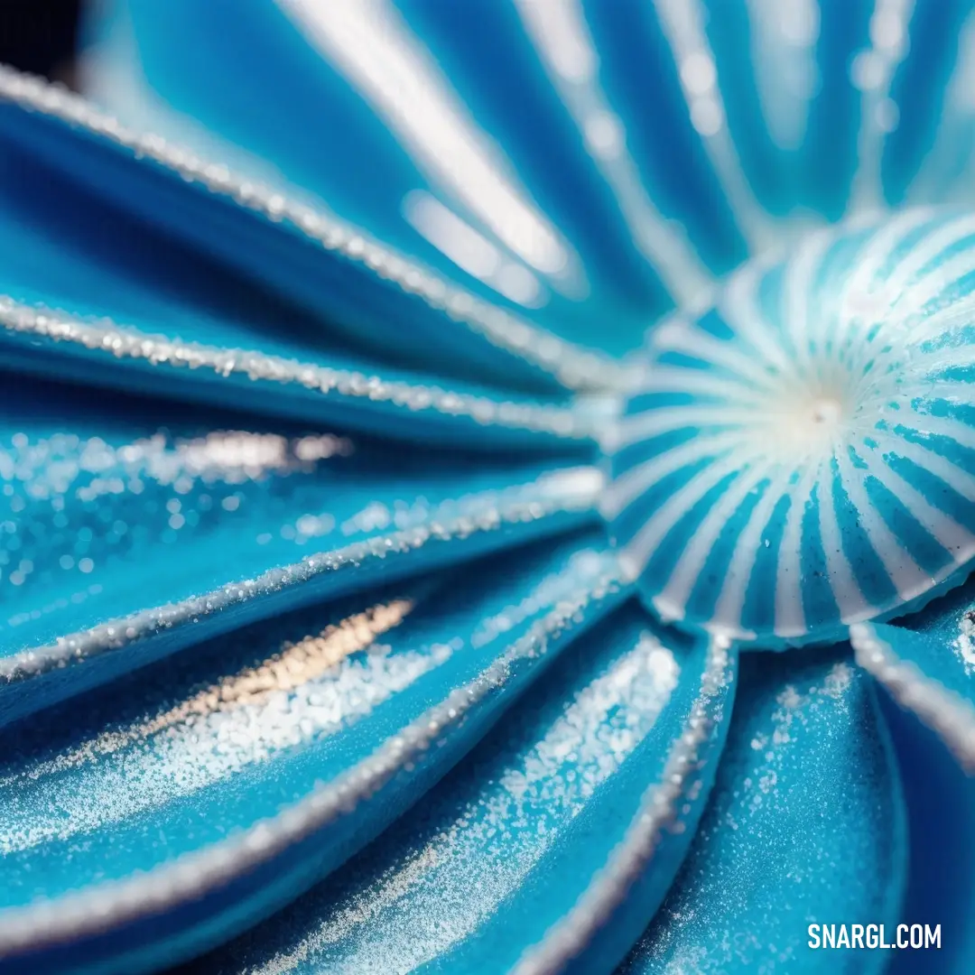 Close up of a blue flower with white stripes on it's petals and a center piece. Example of RGB 0,139,174 color.