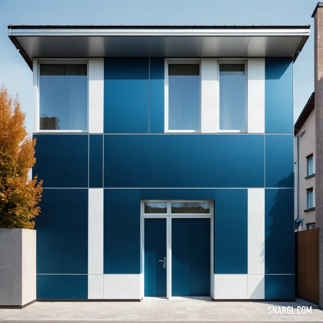 Blue and white building with a door and windows on the side of it. Example of #2F8CBB color.