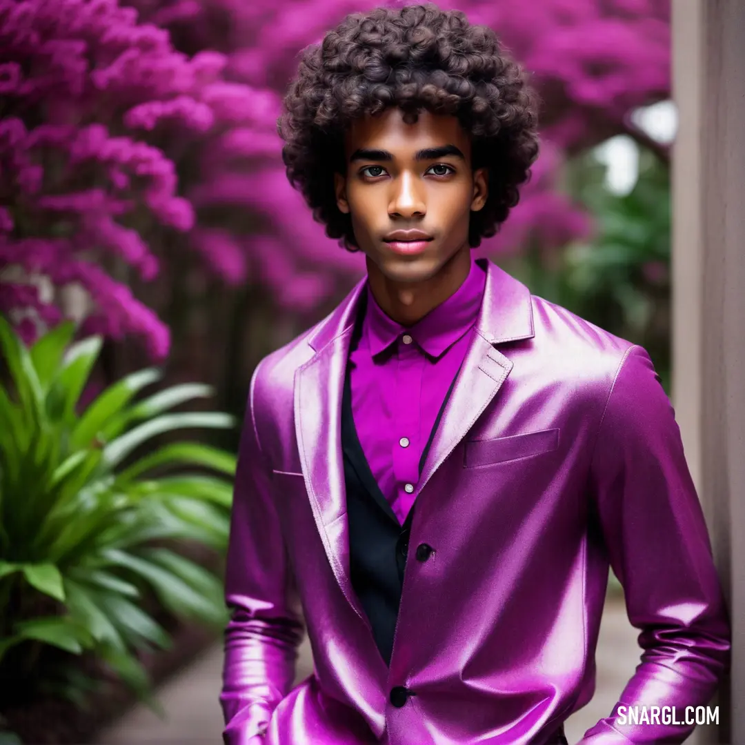 Man in a purple suit standing next to a bush of purple flowers. Color NCS S 2060-R40B.