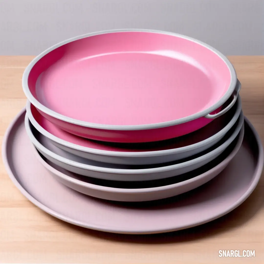 Stack of pink and grey plates on a wooden table top. Color CMYK 0,27,15,40.