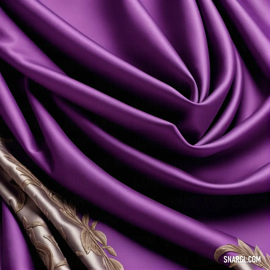 Purple and gold fabric with a gold design on it's side and a gold stripe on the bottom. Example of #9B54A9 color.