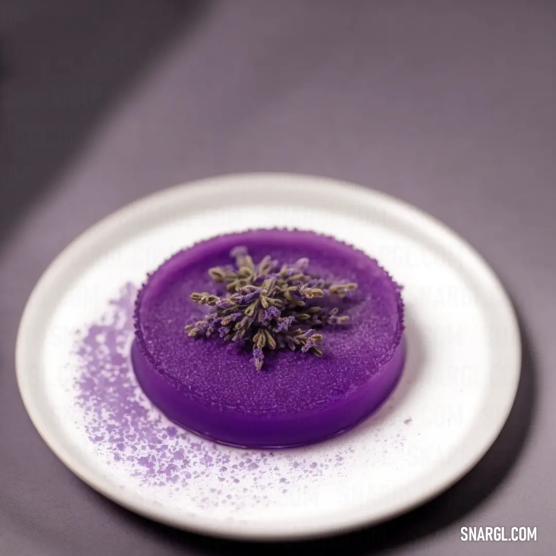Purple substance on a white plate on a tablecloth with a purple background. Example of RGB 129,38,163 color.