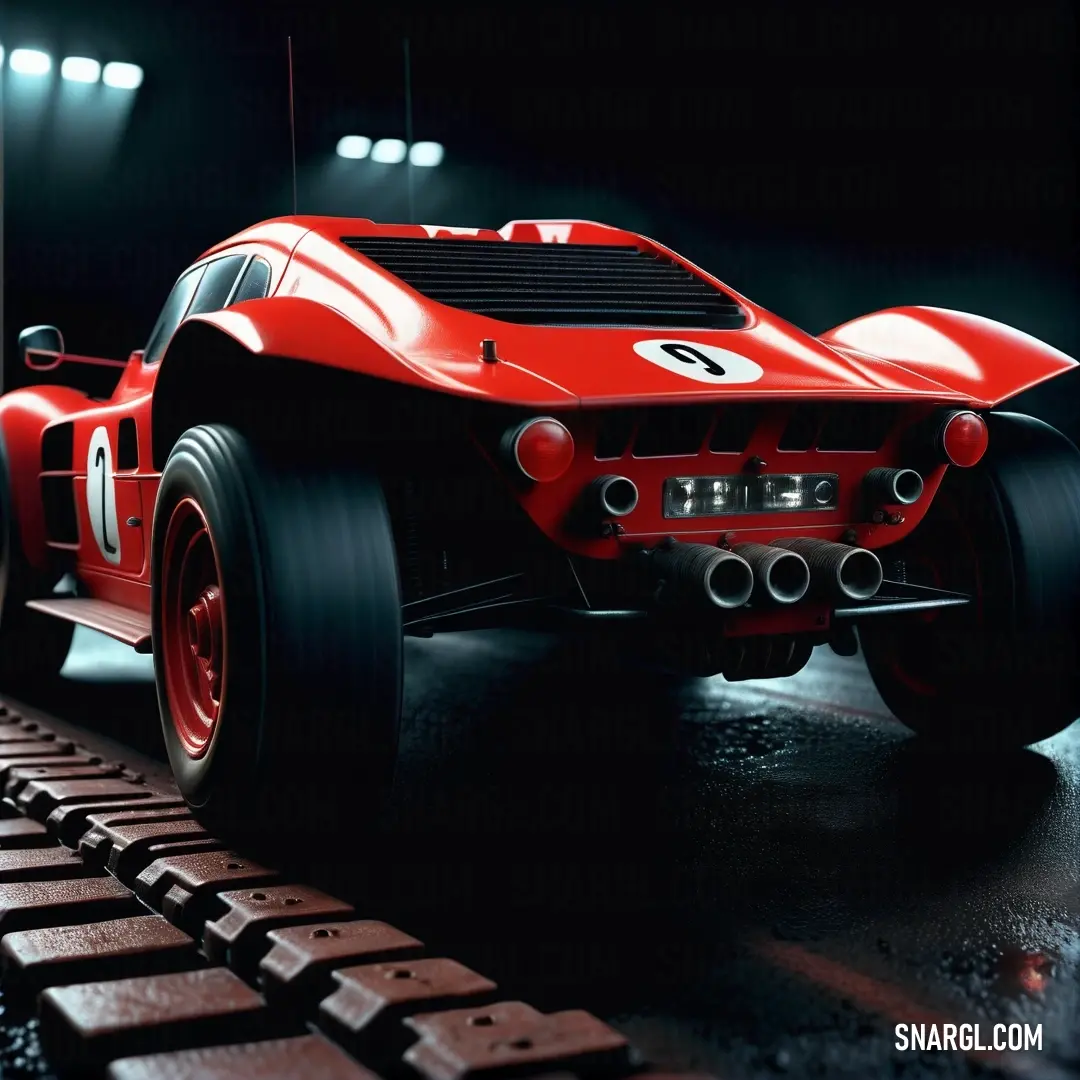 Red race car is on a track in a dark room with lights on the ceiling and a black background. Example of CMYK 0,90,90,35 color.