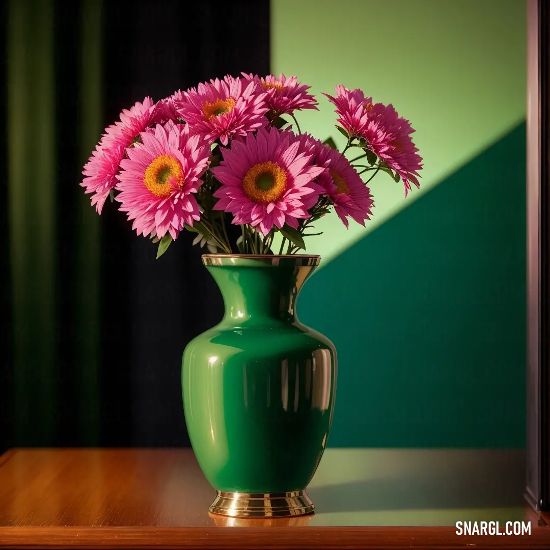 Green vase with pink flowers in it on a table next to a mirror and a green wall behind it. Example of NCS S 3560-G color.